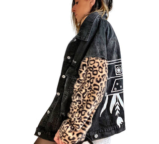 Black denim jacket with super comfortable leopard pattern sleeves. Large white cassette tape painted on back, with white flowers and leaves sprouting out. Signed @wrenandglory.
