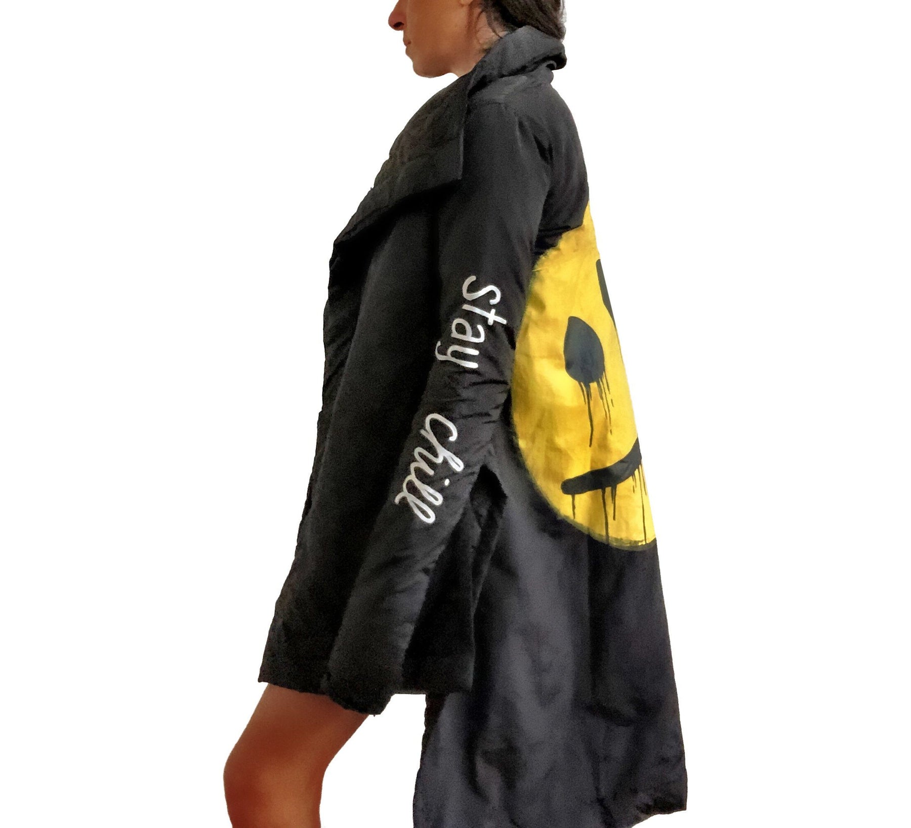 The COOLEST puffer jacket. Large smiley painted on back in yellow, with black drip eyes and mouth. STAY CHILL painted in white on sleeve. Signed @wrenandglory.