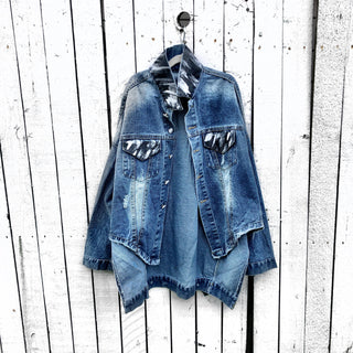 Dark blue denim jacket with long back. White and black pattern painted on back, with ART SCHOOL DROPOUT painted over it in white. Collar and front pockets painted with black and white pattern. Signed @wrenandglory.