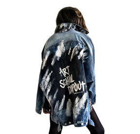 Dark blue denim jacket with long back. White and black pattern painted on back, with ART SCHOOL DROPOUT painted over it in white. Collar and front pockets painted with black and white pattern. Signed @wrenandglory.