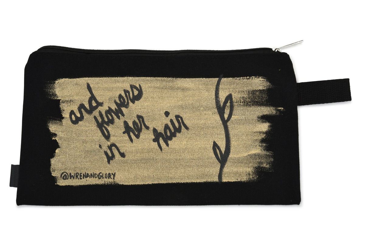 Black denim zippered pouch Hand painted 'She Had Love In Her Eyes' on one side, and 'And Flowers In Her Hair' on the other.
