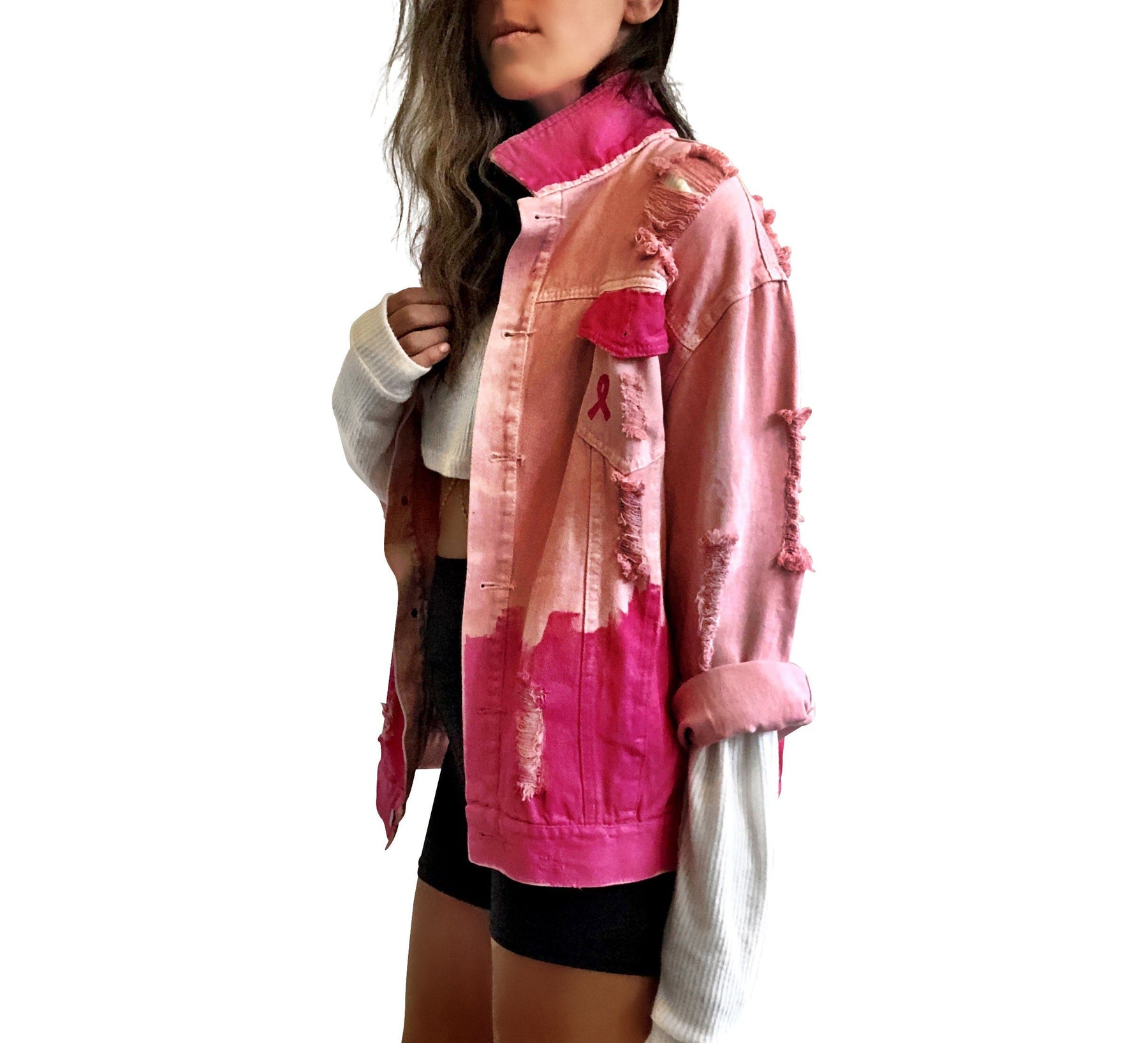 Pink /blush colored denim. Hot pink painted along the bottom half of the jacket, with FIGHT LIKE A GIRL painted in white on back. Small Breast Cancer Awareness ribbon painted on front upper pocket. Signed @wrenandglory.