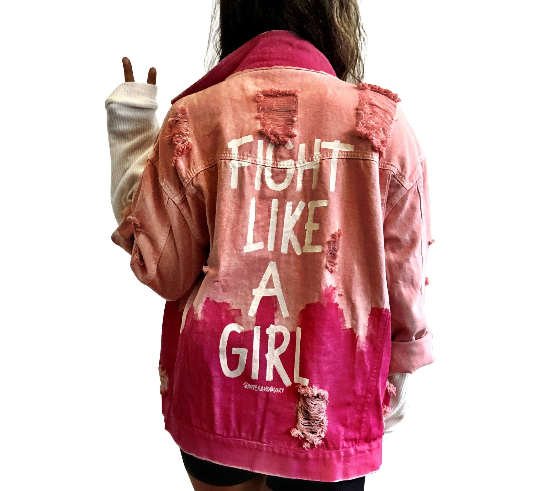 Pink /blush colored denim. Hot pink painted along the bottom half of the jacket, with FIGHT LIKE A GIRL painted in white on back. Small Breast Cancer Awareness ribbon painted on front upper pocket. Signed @wrenandglory.