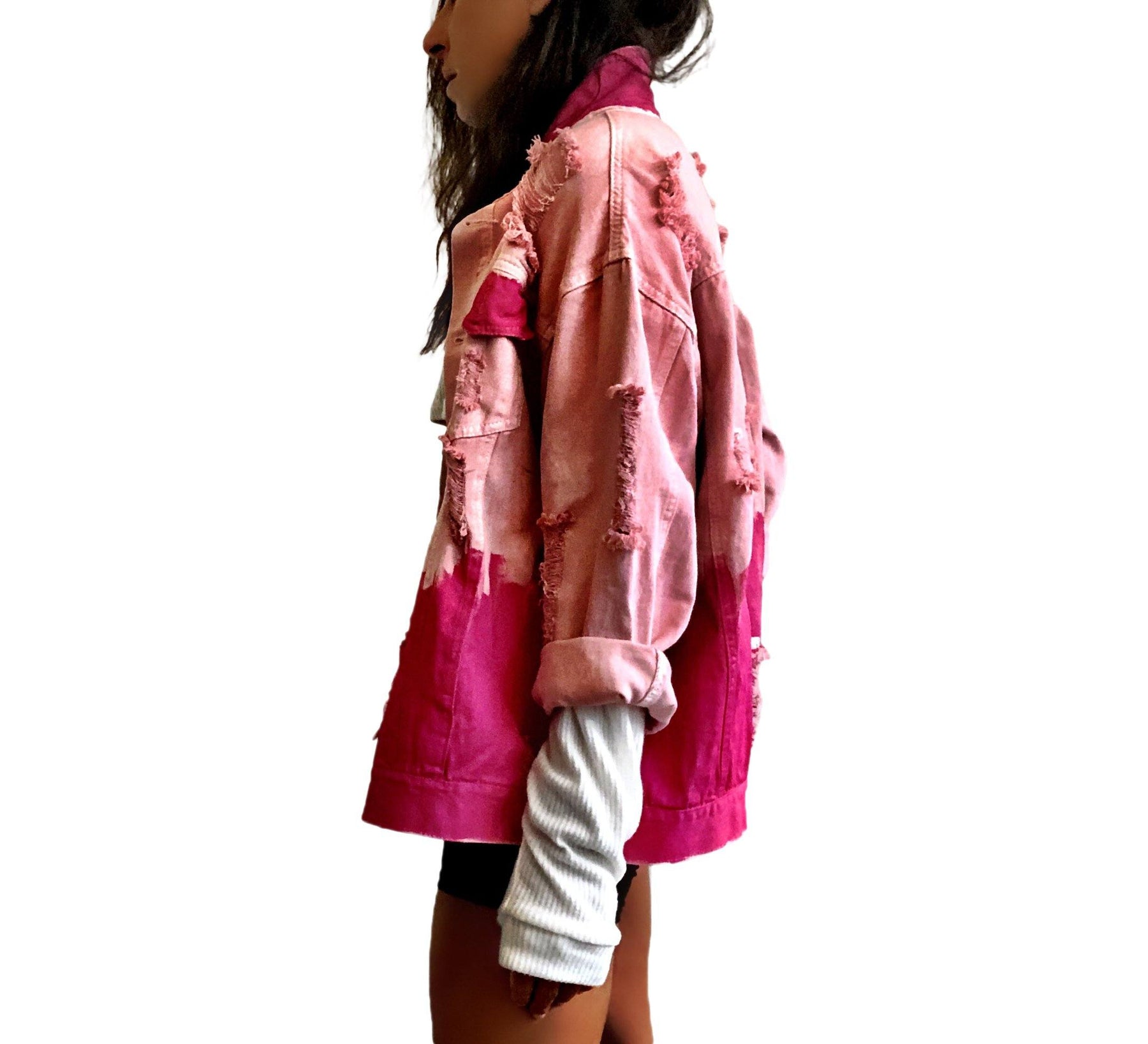 Pink /blush colored denim. Hot pink painted along the bottom half of the jacket, with FIGHT LIKE A GIRL painted in white on back. Small Breast Cancer Awareness ribbon painted on front upper pocket. Signed @wrenandglory.