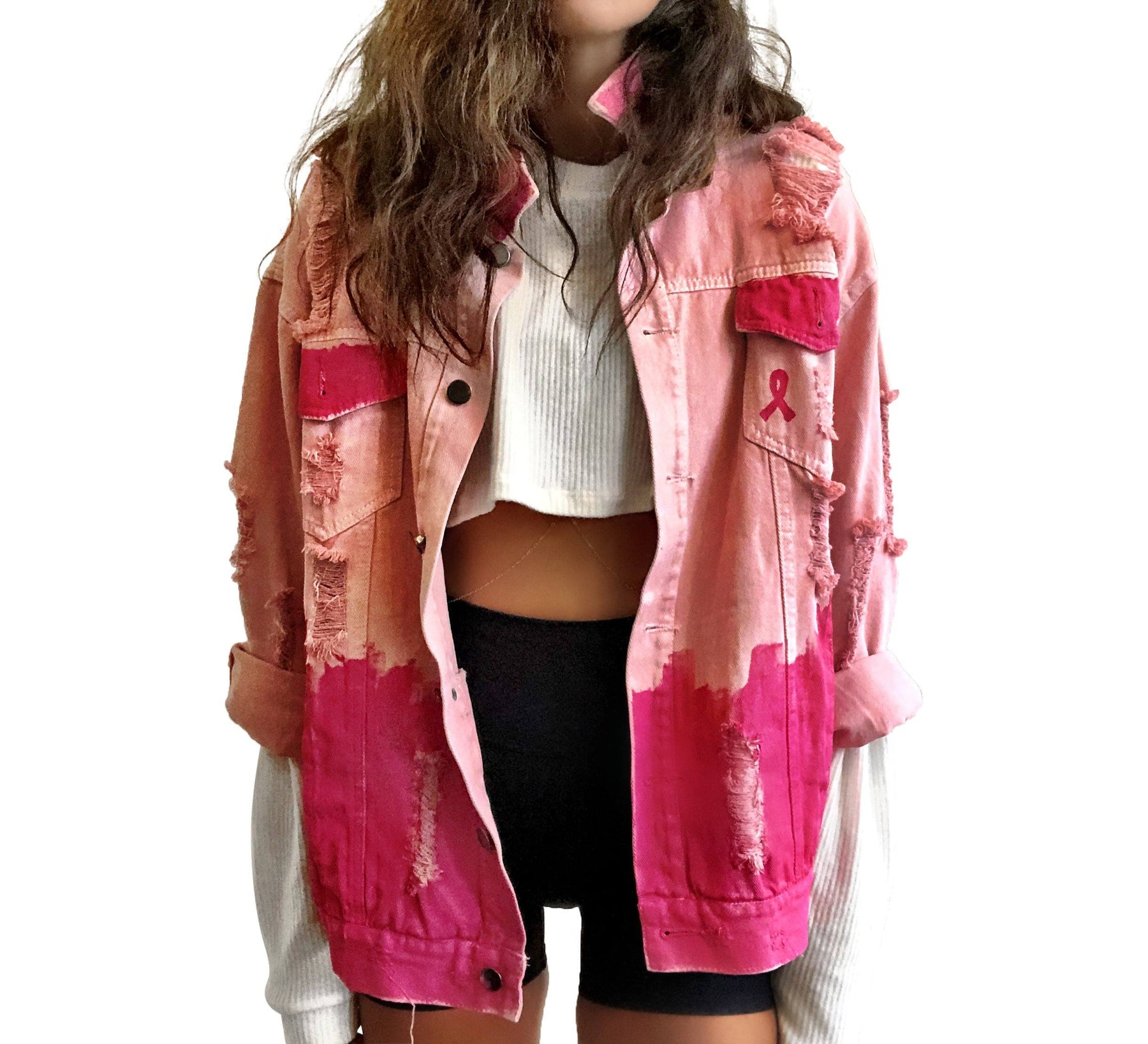 Pink /blush colored denim. Hot pink painted along the bottom half of the jacket, with FIGHT LIKE A GIRL painted in white on back. Small Breast Cancer Awareness ribbon painted on front upper pocket. Signed @wrenandglory.