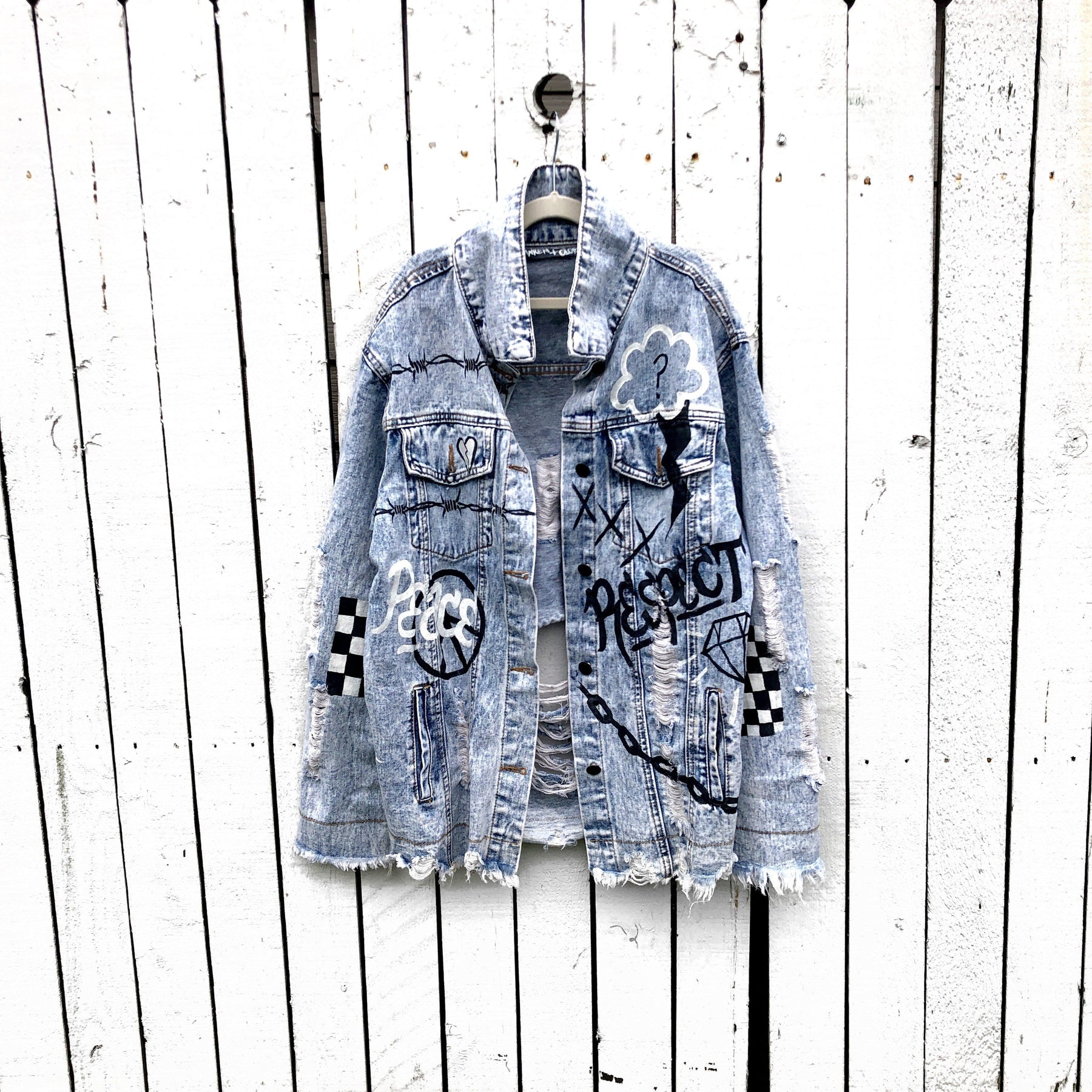 Light blue denim wash. Graffiti style paint throughout entire jacket, in black and white. Choose your name and city to be painted on. Please specify info above. Signed @wrenandglory.