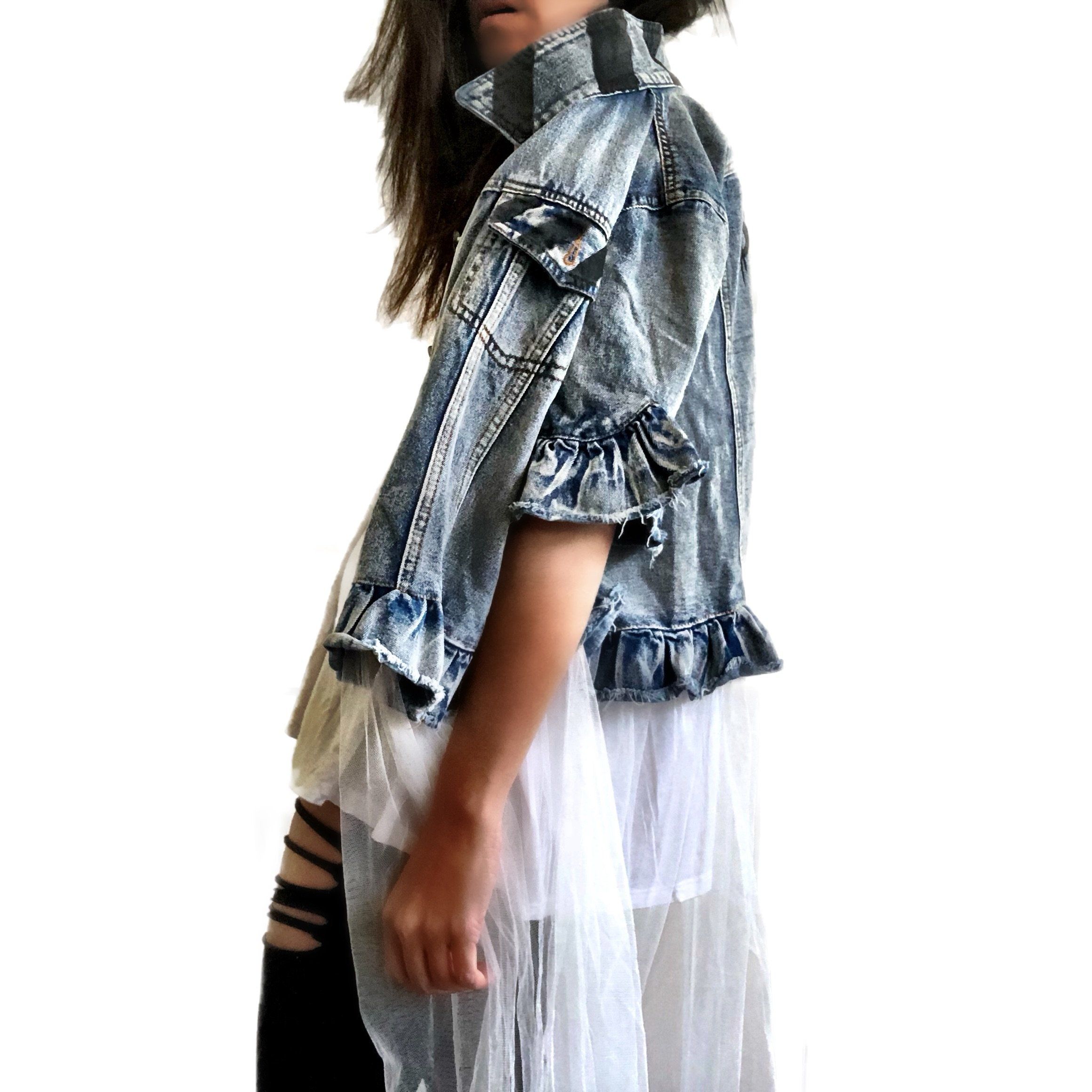 Medium blue denim short sleeve jacket with layer of long white tulle. 'But Is It Art?' painted in black on the back, with black stripes on front pockets and collar. Signed @wrenandglory.