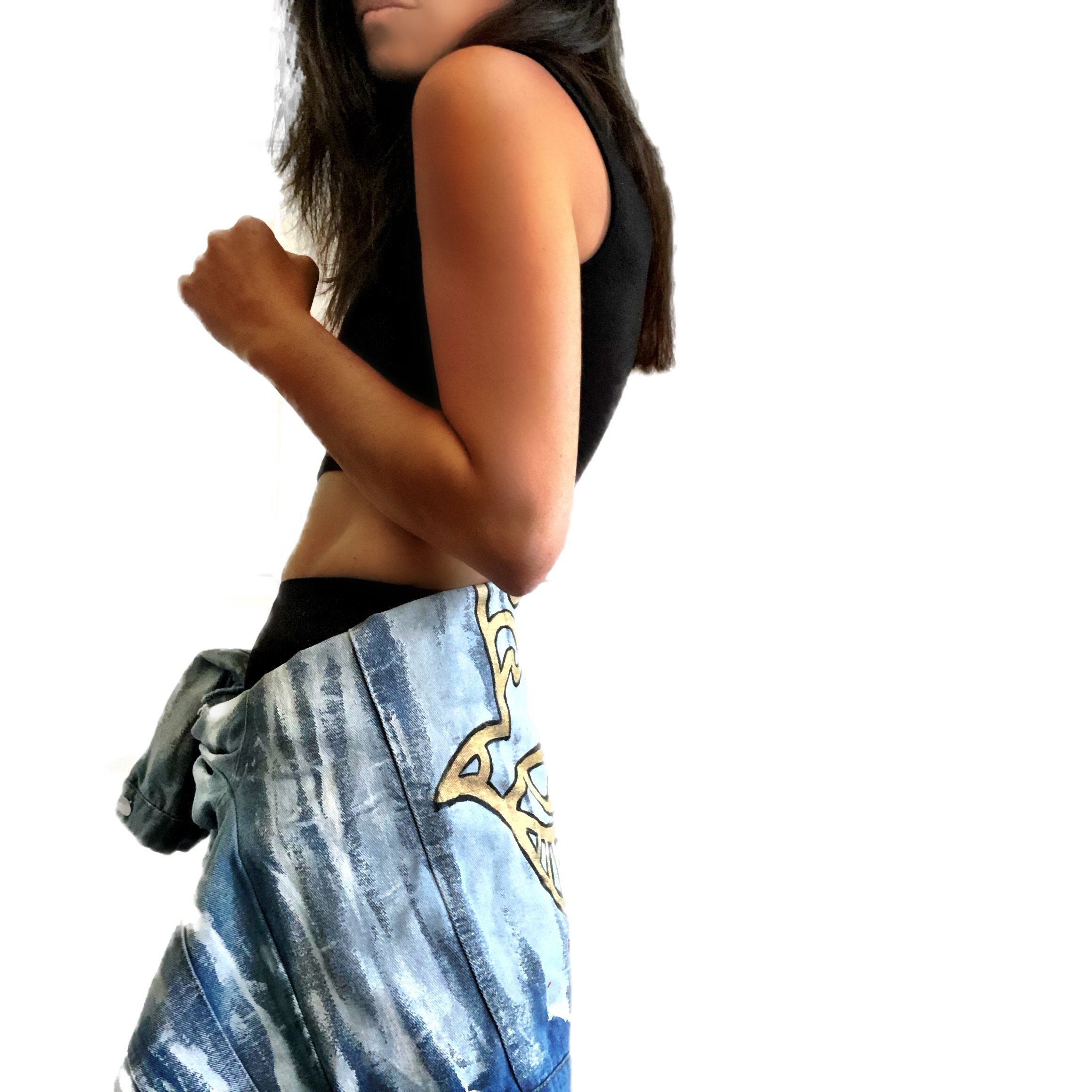 Medium blue denim wash. 'White base all over, with black and gold Hamsa painted on the back. Signed @wrenandglory.