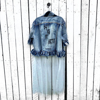 Medium blue denim short sleeve jacket with layer of long white tulle. 'But Is It Art?' painted in black on the back, with black stripes on front pockets and collar. Signed @wrenandglory.