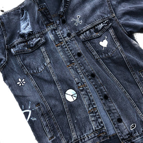 Yellow smiley on faded black denim jacket, with hand painted symbols throughout. Hand painted with white, yellow and black. 'HAPPY DAZE' written down left arm. Signed @wrenandglory