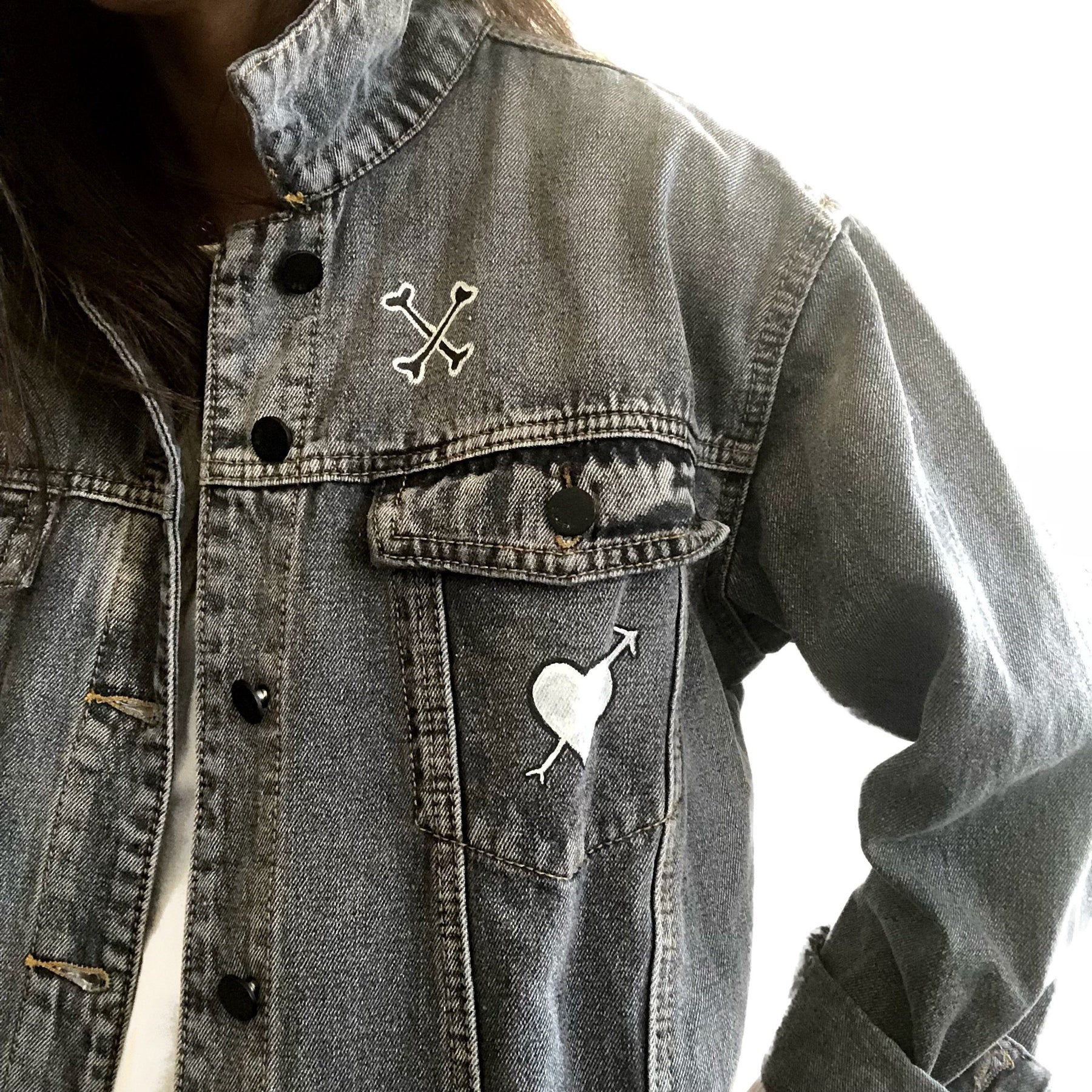 Yellow smiley on faded black denim jacket, with hand painted symbols throughout. Hand painted with white, yellow and black. 'HAPPY DAZE' written down left arm. Signed @wrenandglory