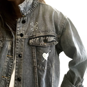 Yellow smiley on faded black denim jacket, with hand painted symbols throughout. Hand painted with white, yellow and black. 'HAPPY DAZE' written down left arm. Signed @wrenandglory