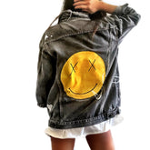 Yellow smiley on faded black denim jacket, with hand painted symbols throughout. Hand painted with white, yellow and black. 'HAPPY DAZE' written down left arm. Signed @wrenandglory