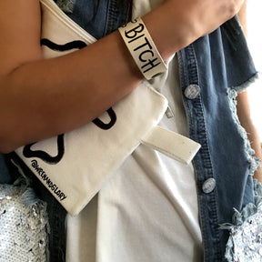 Hand made leather bracelet, hand painted with Bad B*tch and crossbones.  White leather, black paint. Signed W+G