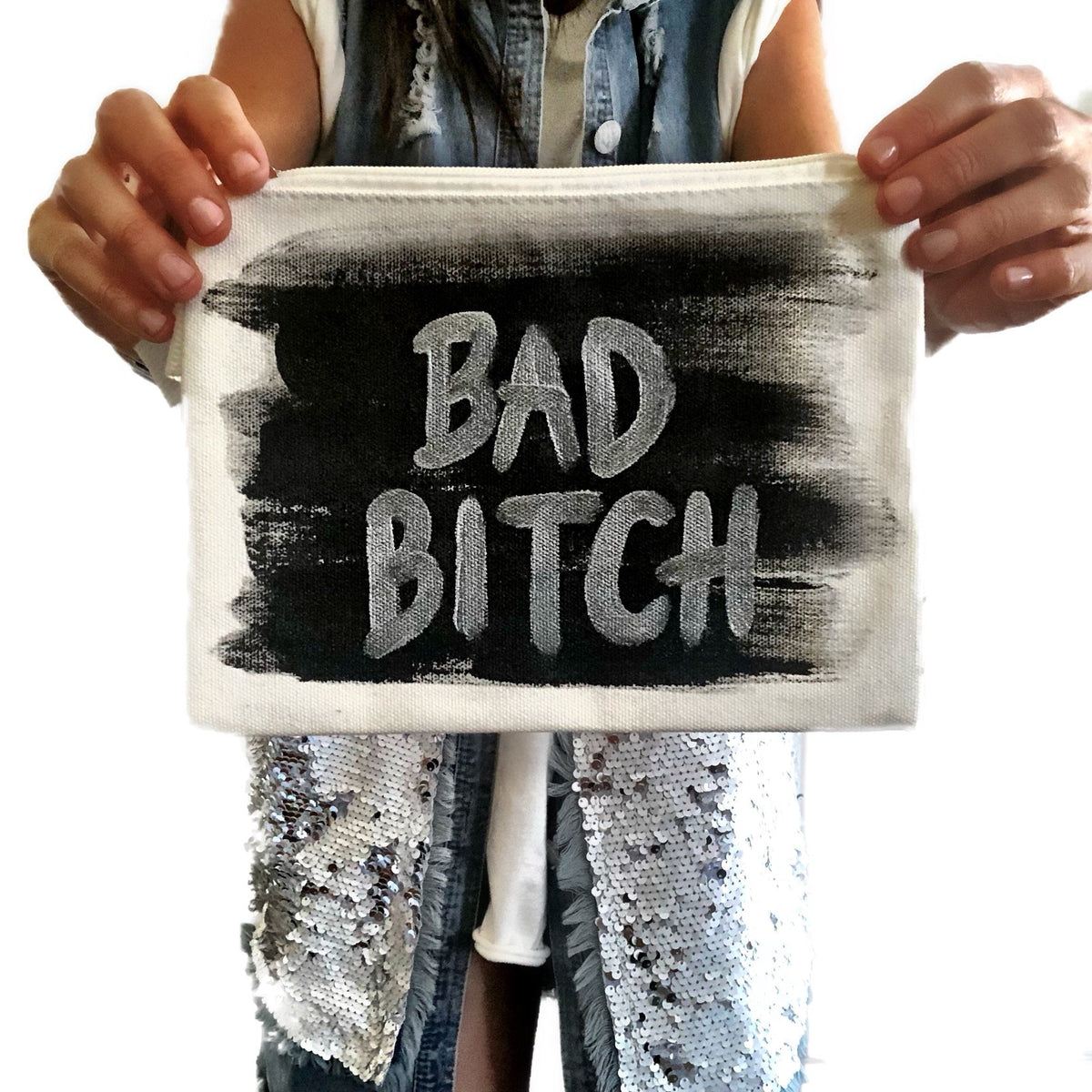 White denim zippered pouch Hand painted 'Bad Bitch' on one side, crossbones on the other.