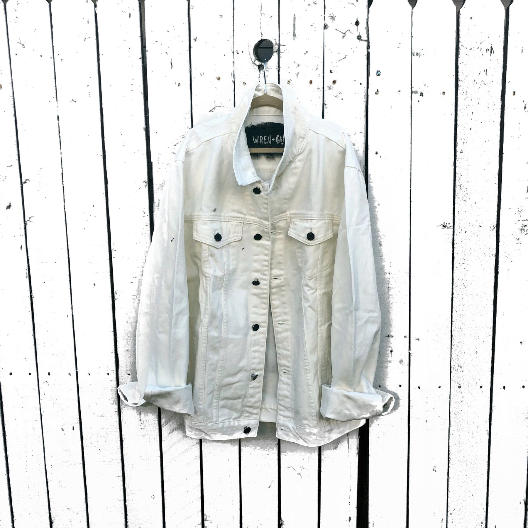 White denim wash. 'Damn The Man Save The Empire' in black and white. Signed @wrenandglory.