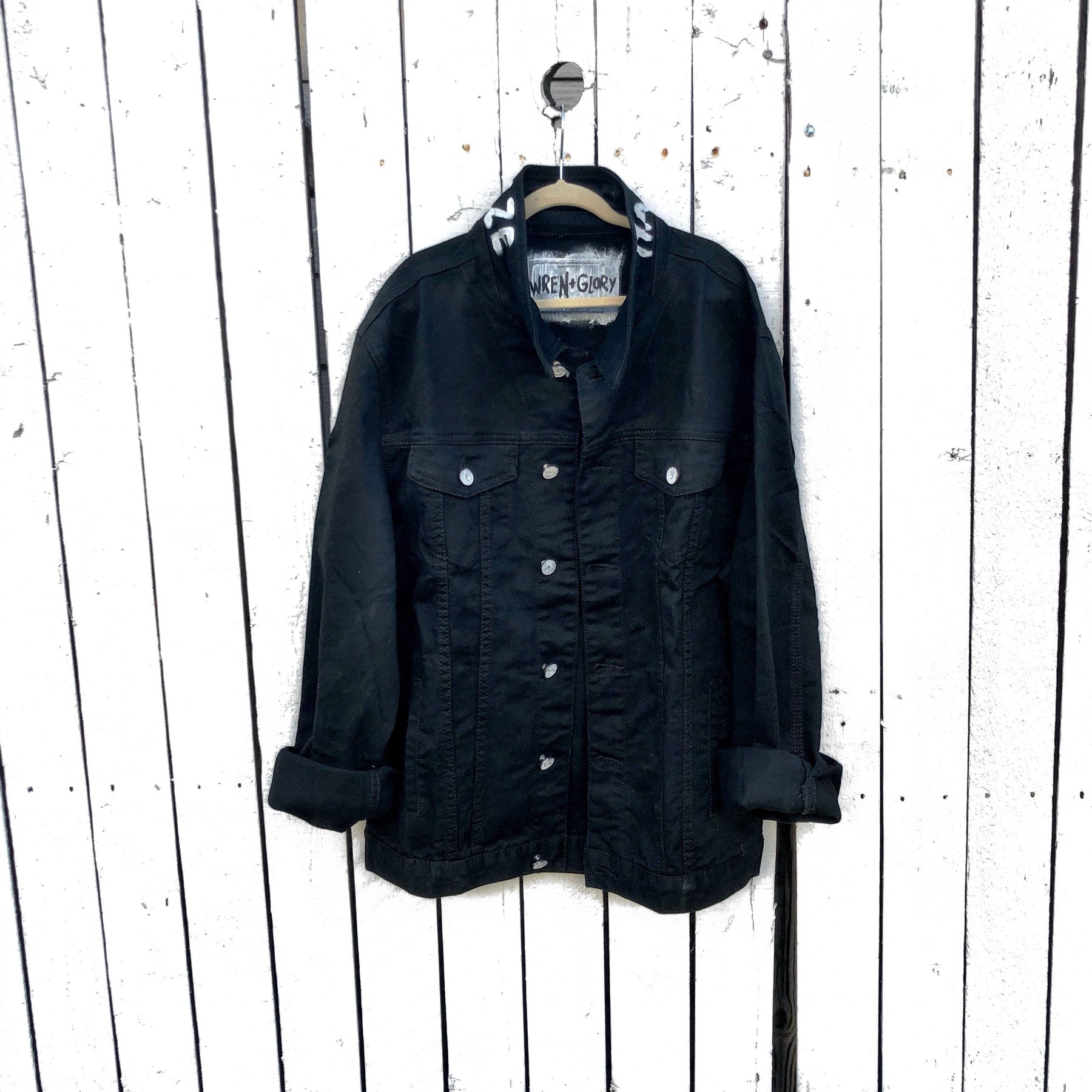 Black denim. Yellow smiley with smoking utensil on back. Happy Daze painted on collar in white. Signed @wrenandglory.