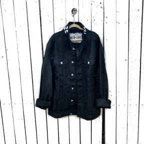 Black denim. Yellow smiley with smoking utensil on back. Happy Daze painted on collar in white. Signed @wrenandglory.
