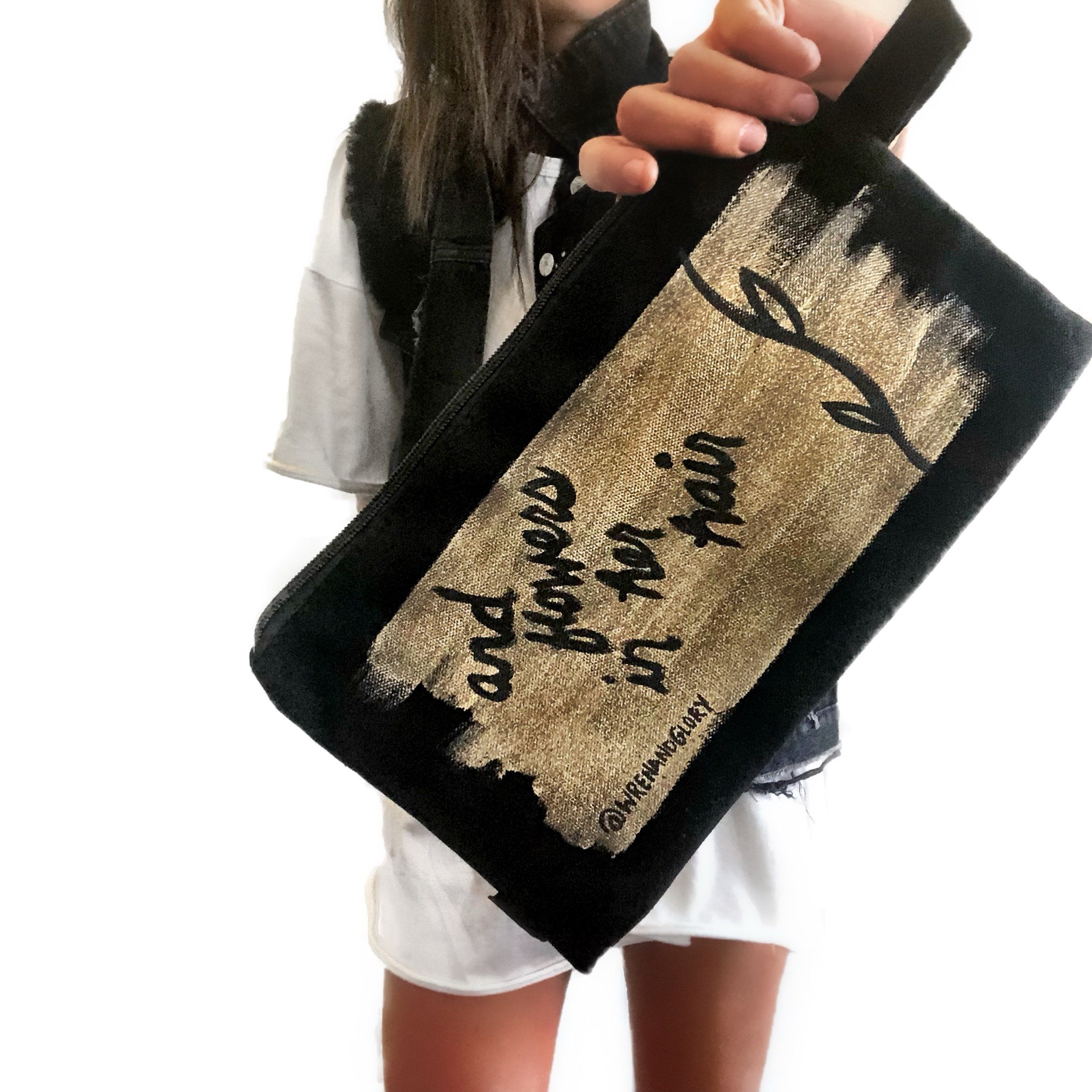 Black denim zippered pouch Hand painted 'She Had Love In Her Eyes' on one side, and 'And Flowers In Her Hair' on the other.