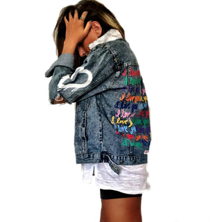 Medium blue denim wash. 'I Love You' painted in rainbow cursive, over and over. White painted pockets and collar, with dripping heart on arm. Signed @wrenandglory.