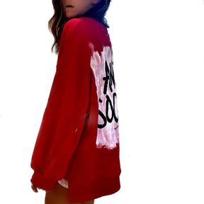 Oversized red sweatshirt. 'ANTI SOCIAL' painted in black, over white, on back Small red embroidered heart on each lower sleeve. Signed @wrenandglory.