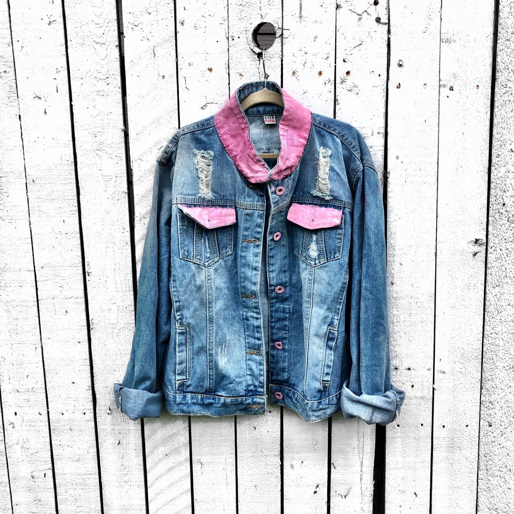 Light blue denim wash. Large pink ribbon, in honor of Breast Cancer, with 'Fight Like A Girl' painted on the back. Pockets and collar painted in pink Signed @wrenandglory.