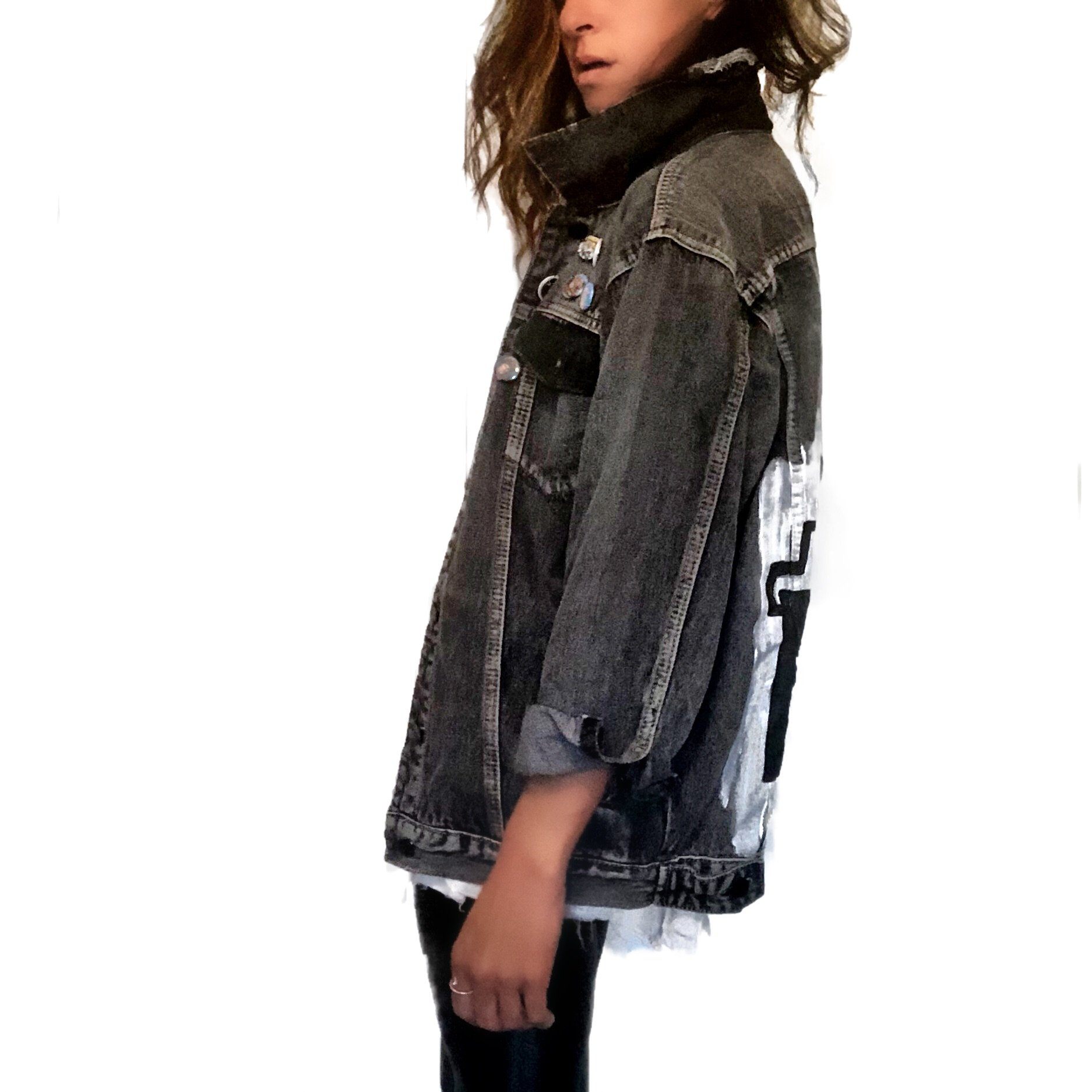 Faded black denim. Boombox painted on back over white base, with wording 'LIVE, LOVE, MUSIC'. Assorted 1 inch pins on front upper side. Signed @wrenandglory.