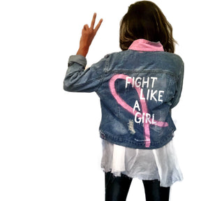 Light blue denim wash. Large pink ribbon, in honor of Breast Cancer, with 'Fight Like A Girl' painted on the back. Pockets and collar painted in pink Signed @wrenandglory.