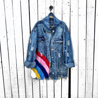 Medium blue denim wash. Large rainbow, spreading across the back to the front, with 'All We Need Is Love' painted in white with a dripping effect. Signed @wrenandglory.