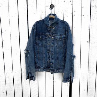 Medium blue denim wash. 'Loved' painted in white, block cursive, outlines with black on lower back, with row of assorted sized heart clusters down the back center. Signed @wrenandglory.