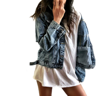 Medium blue denim wash. 'Loved' painted in white, block cursive, outlines with black on lower back, with row of assorted sized heart clusters down the back center. Signed @wrenandglory.