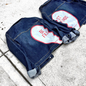Medium blue denim wash. Broken hearts, one on each jacket, with BEST FRIENDS split up between the 2 jackets. White stripes on diagonal on fronts, pockets painted white. Signed @wrenandglory.