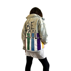 Perfect denim puffer jacket. Rainbow colors painted all across bottom, with BE COOL painted on large on back. Signed @wrenandglory.