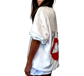 Oversized white sweatshirt. Lips and vampire teeth painted in on back, with with BITE ME painted above. Signed @wrenandglory.