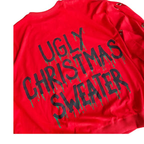 Oversized, batwing red sweatshirt with rings on sleeves. UGLY CHRISTMAS SWEATER painted on the back in black, with green paint drips coming from letters. Signed @wrenandglory