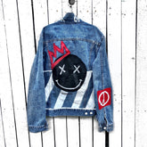 Medium blue denim wash. Black smily with red crown on back. Red crown and design on arm and front. White stripes on lower side on back. 'Fuck Off' painted in white on collar.. Signed @wrenandglory.