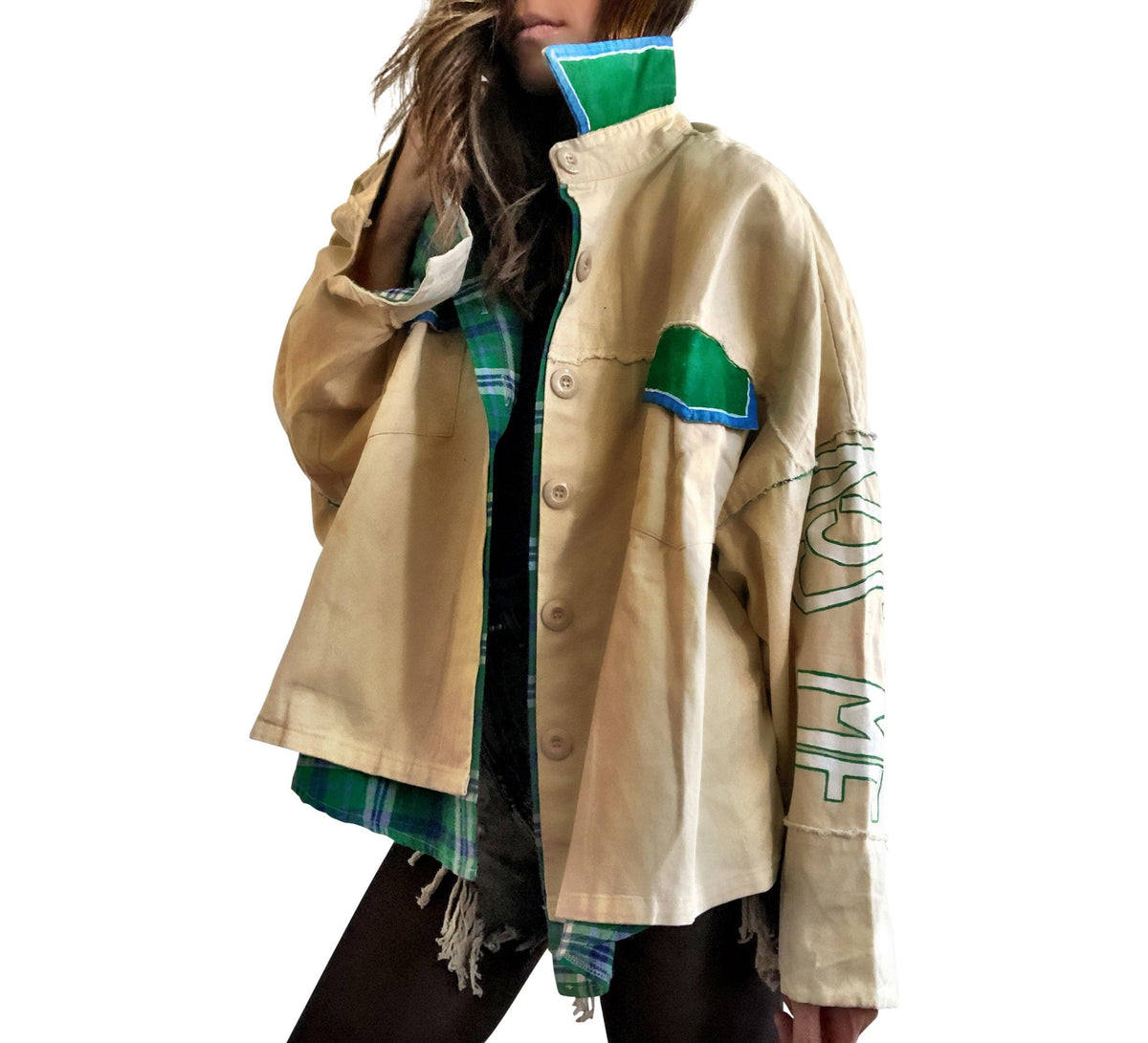 Khaki colored jacket, with green flannel print inside. Large green clover painted on back, with KISS ME down the arm in green and white. Signed @wrenandglory.