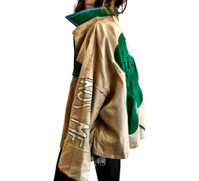 Khaki colored jacket, with green flannel print inside. Large green clover painted on back, with KISS ME down the arm in green and white. Signed @wrenandglory.