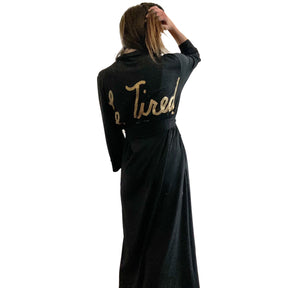Black, super soft, stretch cotton. robe. LE TIRED painted on the back in gold. Belted, with inside ties for secure closure. Signed @wrenandglory.