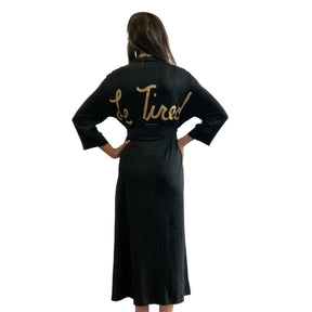 Black, super soft, stretch cotton. robe. LE TIRED painted on the back in gold. Belted, with inside ties for secure closure. Signed @wrenandglory.
