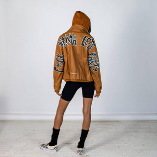 Tan, faux leather jacket with Brown hooded sweatshirt lining the inside and thumbholes at sleeves. 'F*CK DRAMA LET'S PARTY' painted along back of sleeves and upper back of jacket, in black, with white outline. Signed @wrenandglory.
