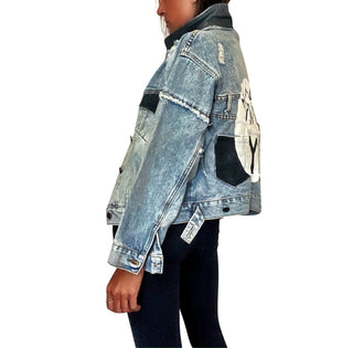 Lighter blue denim wash. White circle, painted MADE IN NYC inside in black.  Pockets and hems painted black Signed @wrenandglory.