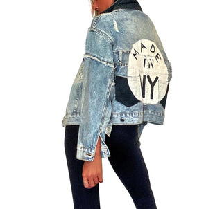 Lighter blue denim wash. White circle, painted MADE IN NYC inside in black.  Pockets and hems painted black Signed @wrenandglory.