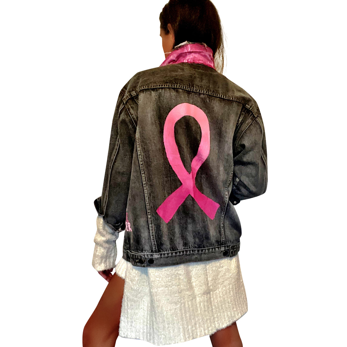 Faded black denim. Pink ombre Breast Cancer ribbon painted in large on back. Love, Strength, Trust, Beauty, Peace, Hope, Passion, Faith, Power painted in light & bright pink on the front. Collar painted in pink ombre. Signed @wrenandglory.