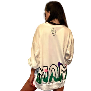 Oversized white sweatshirt. 'MOM' painted in on back, coming up from bottom hem, with flower pattern painted throughout letters. Customized upper back with names of children, grandchildren, husband, etc. Up to 8 names able to be painted. Small red embroidered heart on each lower sleeve. Signed @wrenandglory.