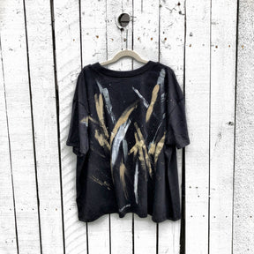 The perfect cropped black T shirt. Assorted color metallics and white splatter and stripes painted on back, with small stars painted on front, upper left side in gold. Signed @wrenandglory.