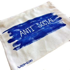 White denim zippered pouch. Hand painted 'ANTI SOCIAL' design. Signed @wrenandglory.