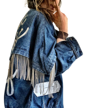 Darker blue denim wash with silver chains. 'DARLING JUST BELIEVE IN YOURSELF' painted in white script on back. Color and front pockets painted white. Signed @wrenandglory.