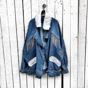 Darker blue denim wash with silver chains. 'DARLING JUST BELIEVE IN YOURSELF' painted in white script on back. Color and front pockets painted white. Signed @wrenandglory.