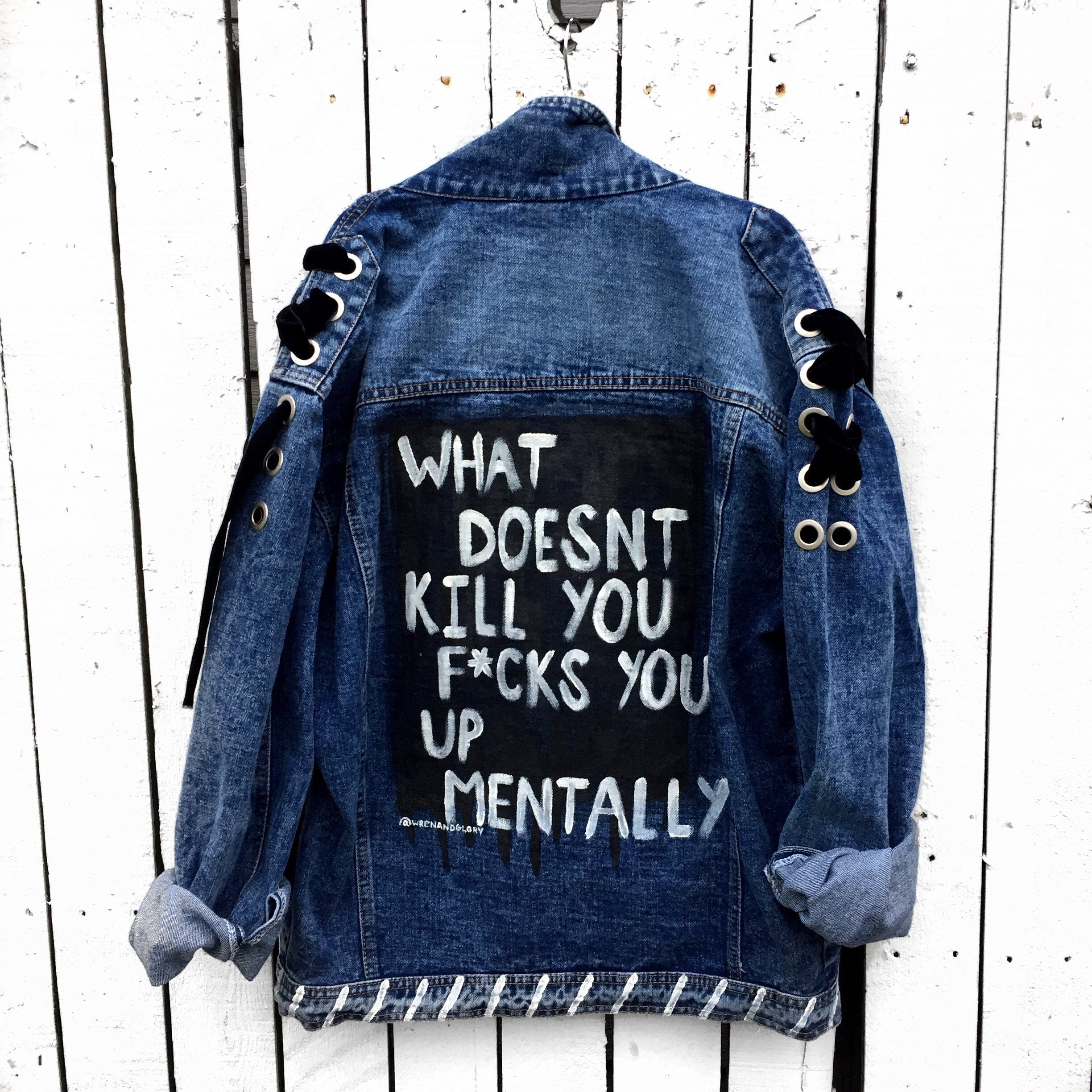 Darker blue denim with black velvet ribbons. Black base, painted 'What Doesn't Kill You F*cks You Up Mentally' in white. White stripes painted on collar an bottom hem. Signed @wrenandglory.